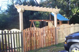 This is a custom made arbor over a double fence gate