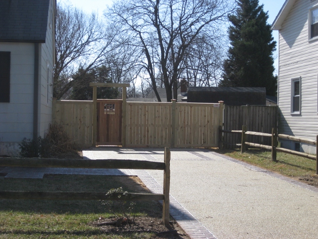 Custom made flat board fence with bottom and top trim board on 6 x 6 posts